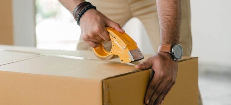 Picture of a person packing a box 