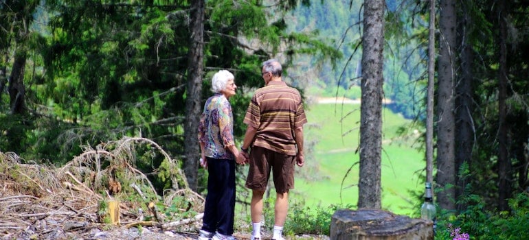 Seniors in the woods holding hands