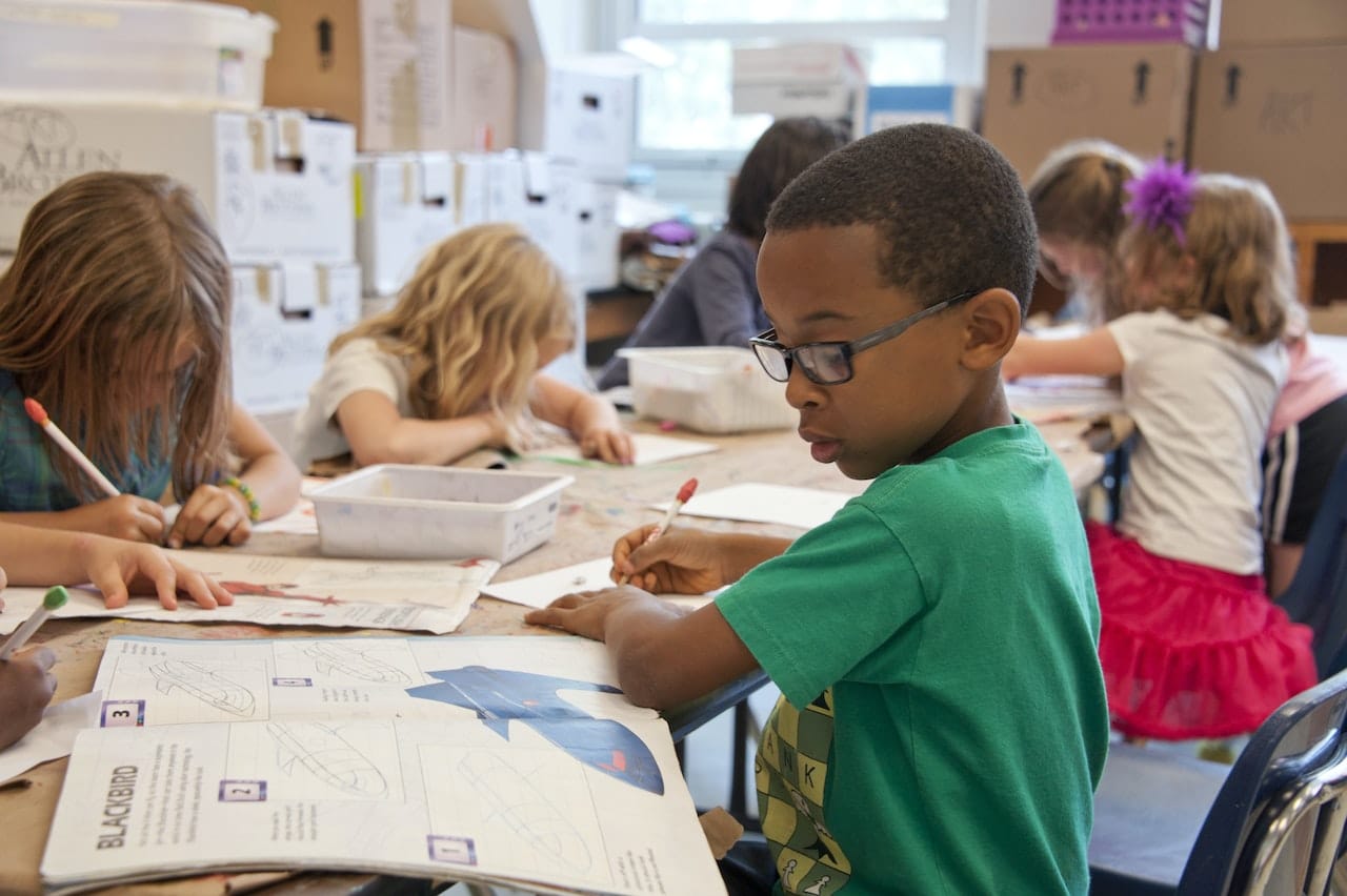 A child drawing in art class at one of the best schools in Santa Clara County