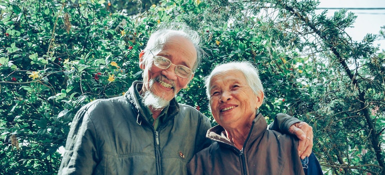 An older couple smiling and posing for a photo