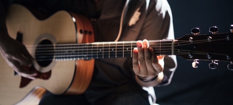 Picture of a person that is playing the guitar 