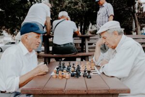 Elderly men playing chess while discussing is San Francisco senior friendly