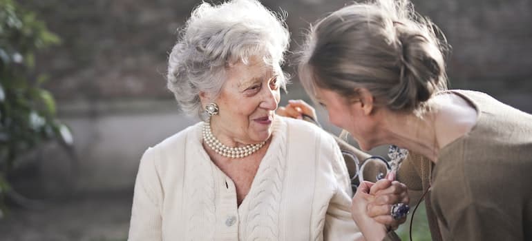 an older woman talking to her granddaughter.